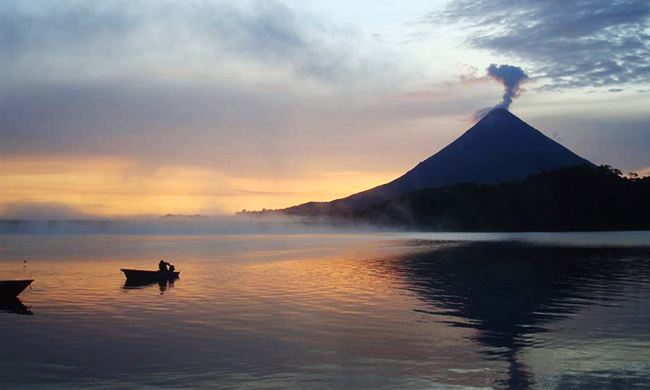Sun setting at Lake Arenal with the volcano in the background